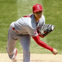 Angels two-way player Shohei Ohtani pitches against the Athletics on July 26 in Oakland. He surrendered five runs without an out in his first appearance on the mound in two seasons. | GETTY / VIA KYODO