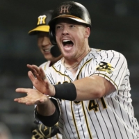The Tigers' Justin Bour celebrates after hitting a home run against the Giants at Koshien Stadium in Nishinomiya, Hyogo Prefecture, on July 9. | KYODO 