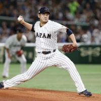 Japan starter Tomoyuki Sugano pitches against Cuba during the World Baseball Classic on March 14, 2017. Sugano has been posted by Yomiuri, giving major league teams one month to approach two-time Sawamura Award winner and negotiate a deal. | AP