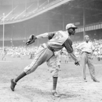 Kansas Monarchs pitcher Satchel Paige warms up before a game between the Monarchs and the New York Cuban Stars in New York on Aug. 2, 1942. | AP