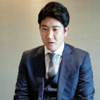 Tomoyuki Sugano speaks to reporters after signing a reported ¥800 million, one-year contract with the Giants on Thursday. | YOMIURI GIANTS / VIA KYODO