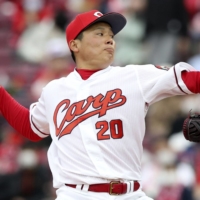 Carp closer Ryoji Kuribayashi pitches against the Dragons on Saturday at Mazda Stadium in Hiroshima. | KYODO