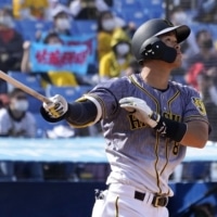 The Tigers' Teruaki Sato homers against the Swallows during the fourth inning at Jingu Stadium on March 16. | KYODO
