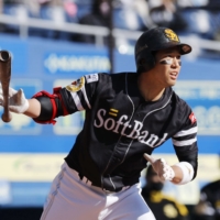 The Hawks' Ryoya Kurihara hits a home run against the Marines during the seventh inning of a spring training game in Chiba on March 14. | KYODO