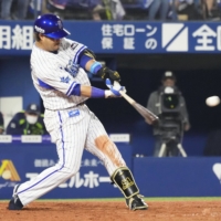 BayStars third basemen Toshiro Miyazaki hits an RBI double against the Swallows during the third inning at Yokohama Stadium on Tuesday. | KYODO
