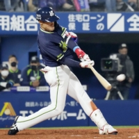 The Swallows' Yasutaka Shiomi connects on a game-tying two-run double against the BayStars at Yokohama Stadium on Tuesday. | KYODO