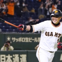 The Giants' Yoshiyuki Kamei begins to celebrate after hitting a game-winning home run against the BayStars at Tokyo Dome on Friday. | KYODO