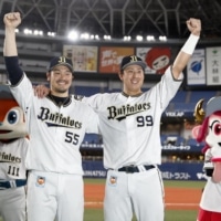 The Buffaloes' Yutaro Sugimoto (right) and Takahiro Okada celebrate after their win over the Lions in Osaka on Thursday. | KYODO