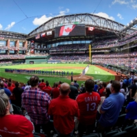 Fans stand for the national anthems of Canada and the United States before the Rangers host the Blue Jays on Monday in Arlington, Texas. | USA TODAY / VIA REUTERS