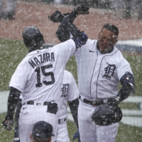 Tigers first baseman Miguel Cabrera celebrates with teammates Nomar Mazara after hitting a two-run home run against the Indians in Detroit on Thursday. | USA TODAY / VIA REUTERS