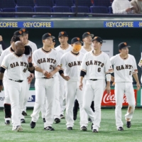 The Giants walk onto the field after a 1-1 tie against the BayStars on March 28 at Tokyo Dome. | KYODO