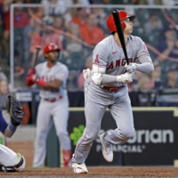 Angels designated hitter Shohei Ohtani connects on a solo home run against the Astros during the eighth inning in Houston on Sunday. | AP / VIA KYODO