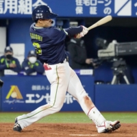 The Swallows' Yasutaka Shiomi drives in a run against the BayStars during the fifth inning on Wednesday in Yokohama. | KYODO