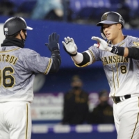 Tigers rookie Teruaki Sato turned heads with a home run that left Yokohama Stadium on Friday night. | KYODO