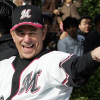 Then-Chiba Lotte Marines manager Bobby Valentine gestures during a victory parade in the city of Chiba in November 2005 after the Marines won the Asia Series. | REUTERS