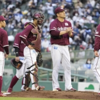 Rakuten players meet on the mound after Masahiro Tanaka (second from right) surrenders the lead against Orix in the sixth inning on Saturday in Kobe. | KYODO