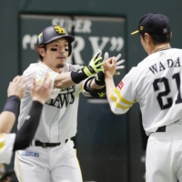 SoftBank Hawks infielder Nobuhiro Matsuda celebrates with pitcher Tsyuoshi Wada after hitting a home run against the Orix Buffaloes during the fourth inning on Sunday in Fukuoka. | KYODO