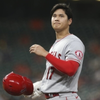 Angels pitcher Shohei Ohtani adjusts his helmet after hitting a single against the Astros on Tuesday in Houston. | USA TODAY / VIA REUTERS