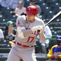 Angels designated hitter Shohei Ohtani is hit by a pitch during the first inning against the Mariners in Seattle on Sunday. | KYODO