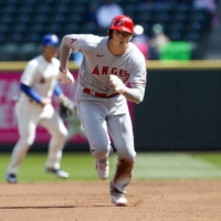 Angels designated hitter Shohei Ohtani steals third base against the Mariners on Sunday in Seattle. | USA TODAY / VIA REUTERS