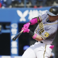 Hanshin's Yoshio Itoi hits a two-run home run during the fifth inning against the BayStars in Yokohama on Sunday. | KYODO