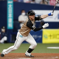 The Fighters' Yuto Takahama connects on an RBI single against the Buffaloes in Osaka on Thursday. | KYODO