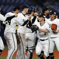 Buffaloes players celebrate after their win over the Fighters on Wednesday in Osaka. | KYODO