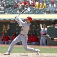 Shohei Ohtani connects on his 19th home run of the season during the second inning against the Athletics on Wednesday in Oakland, California. | KYODO