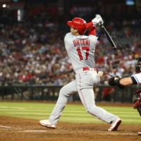 The Los Angeles Angels' Shohei Ohtani hits a double in the seventh inning against the Arizona Diamondbacks at Chase Field in Phoenix on Friday. | USA TODAY / VIA REUTERS