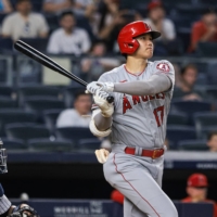 Angels designated hitter Shohei Ohtani watches his second home run of the game against the Yankees on Tuesday in New York. | USA TODAY / VIA REUTERS