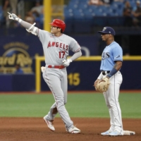 Shohei Ohtani of the Los Angeles Angels reacts after hitting an RBI double Sunday in the sixth inning of a game against the Tampa Bay Rays, at Tropicana Field in St. Petersburg, Florida. | KYODO 
