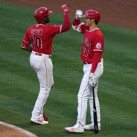 Los Angeles Angels left fielder Justin Upton celebrates with starting pitcher Shohei Ohtani after Upton's solo home run in the third inning against the Seattle Mariners on Friday. | USA TODAY / VIA REUTERS