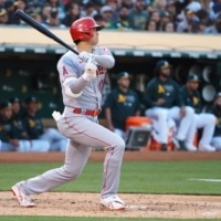 The Angels' Shohei Ohtani hits a double against the Athletics in Oakland, California, on Monday. | KYODO