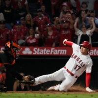 Los Angeles Angels designated hitter Shohei Ohtani slides into home to score the winning run in the bottom of the ninth inning against the Baltimore Orioles on Friday at Angel Stadium. | USA TODAY / VIA REUTERS