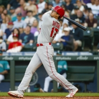 Los Angeles Angels designated hitter Shohei Ohtani hits a solo home run against the Seattle Mariners during the third inning at T-Mobile Park in Seattle on Friday. | USA TODAY / VIA REUTERS