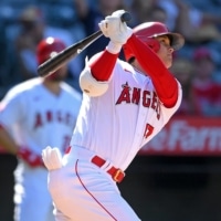 Angels designated hitter Shohei Ohtani hits a two-run home run for his 34th of the season against the Seattle Mariners at Angel Stadium in Anaheim, California on Sunday. | USA TODAY / VIA REUTERS