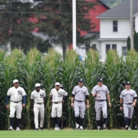 The White Sox and Yankees enter the field before the 'Field of Dreams' game in Dyersville, Iowa, on Thursday. | USA TODAY / VIA REUTERS