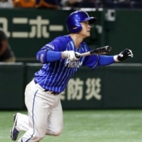 Tatsuhiro Shibata hits his second home run for the BayStars against the Giants on Saturday at Tokyo Dome. | KYODO