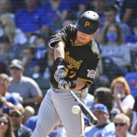 Yoshitomo Tsutsugo of the Pittsburgh Pirates hits a home run in the first inning of a game against the Chicago Cubs in Chicago on Sunday. | GETTY IMAGES / VIA KYODO