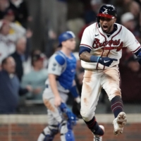 The Braves' Eddie Rosario celebrates after his game-winning single against the Dodgers in Game 2 of the NLCS in Atlanta on Sunday. | USA TODAY / VIA REUTERS