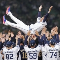 Lions players lift retiring pitcher Daisuke Matsuzaka into the air after his final appearance before retiring on Tuesday in Tokorozawa, Saitama Prefecture. | KYODO