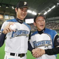 Fighters manager Hideki Kuriyama poses with pitcher Shohei Ohtani following the first pitching win of Ohtani's career on June 1, 2013, at Sapporo Dome. | KYODO