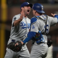 Dodgers pitcher Max Scherzer (left) and catcher Will Smith celebrate after beating the Giants in Game 5 of the NLDS in San Francisco on Thursday. | USA TODAY / VIA REUTERS