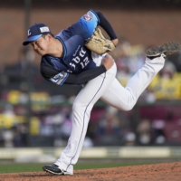 The Lions' Yutaro Watanabe pitches against the Eagles in Sendai on Sunday. | KYODO