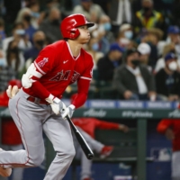 Shohei Ohtani hits a home run against the Mariners in the first inning in Seattle on Sunday. | USA TODAY / VIA REUTERS