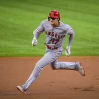 Shohei Ohtani rounds second base base on his way to third for a triple during the first inning against the Rangers in Arlington, Texas, on Thursday. | USA TODAY / VIA REUTERS