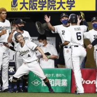 Yuma Mune (6) celebrates at the Orix dugout after hitting a game-tying home run in the eighth inning against the Marines on Tuesday in Osaka. | KYODO