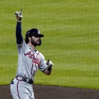 Atlanta Braves shortstop Dansby Swanson (7) celebrates after hitting a two-run home run against the Houston Astros during the fifth inning of Game Six of the World Series on Tuesday in Houston. | USA TODAY / VIA REUTERS