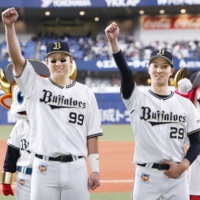 Buffaloes outfielder Yutaro Sugimoto (left) and starting pitcher Daiki Tajima pose after their win over the Marines in Osaka on Thursday. | KYODO
