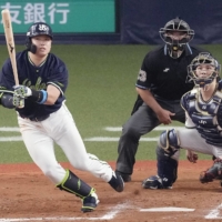 The Swallows' Munetaka Murakami connects on a two-run home run during the eighth inning in Game 1 of the Japan Series in Osaka on Saturday. | KYODO